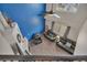 An aerial view of the living room reveals an attractive accent wall, fireplace and comfortable seating at 5149 S Tibet St, Aurora, CO 80015