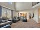 Bright and airy living area featuring plush seating, large windows, and an open layout to the kitchen at 5149 S Tibet St, Aurora, CO 80015