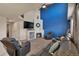 Cozy living room offers a fireplace, high ceilings, blue accent wall and plush seating at 5149 S Tibet St, Aurora, CO 80015