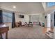 Large living room featuring carpeted floors, with many large windows, providing ample natural light at 5149 S Tibet St, Aurora, CO 80015