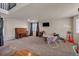 Large living room featuring carpeted floors, a piano, and large windows, perfect for Gathering gatherings at 5149 S Tibet St, Aurora, CO 80015