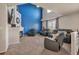 Vaulted living room boasts a fireplace, striking blue accent wall, and comfortable seating at 5149 S Tibet St, Aurora, CO 80015