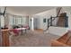 Inviting living area featuring cozy carpeting, bright windows, and stairs to the upper level at 5149 S Tibet St, Aurora, CO 80015