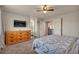 Neutral-toned main bedroom features flat screen TV, closet and attached bath access at 5149 S Tibet St, Aurora, CO 80015