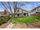 Backyard featuring a grassy lawn, mature trees, a patio, and a home with sliding glass doors at 7942 S Vincennes Way, Centennial, CO 80112