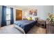 Cozy bedroom with a wood-framed bed, soft lighting, and charming superhero artwork at 7942 S Vincennes Way, Centennial, CO 80112