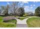 Beautifully landscaped common area with walkway, mature trees, and green space at 7942 S Vincennes Way, Centennial, CO 80112