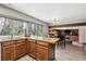 Bright eat-in kitchen featuring a large island and an open layout to a dining area at 7942 S Vincennes Way, Centennial, CO 80112