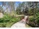 Scenic pathway with a wooden bridge surrounded by mature trees and lush greenery at 7942 S Vincennes Way, Centennial, CO 80112