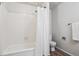 Updated bathroom featuring a white tub/shower combo, wood look flooring, and linen closet at 10950 W Florida Ave # 314, Lakewood, CO 80232