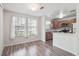 Sun-drenched dining area featuring large windows and adjacent kitchen at 10950 W Florida Ave # 314, Lakewood, CO 80232