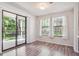 Bright dining area with sliding glass door to balcony and wood-look flooring at 10950 W Florida Ave # 314, Lakewood, CO 80232
