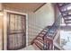 Condo front door and stairway with secure metal security door at 10950 W Florida Ave # 314, Lakewood, CO 80232