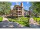 Attractive condo building showcasing balconies, mature trees, and well-manicured landscaping at 10950 W Florida Ave # 314, Lakewood, CO 80232