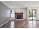 Well-lit living room showcases hardwood floors, stone fireplace, and balcony at 10950 W Florida Ave # 314, Lakewood, CO 80232