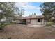 Backyard view with a covered patio, landscaping, mature trees, and privacy fence surrounding the property at 3312 S Ouray Way, Aurora, CO 80013