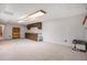 Spacious unfinished basement with neutral carpet, wood cabinets, utility sink, and good lighting at 3312 S Ouray Way, Aurora, CO 80013