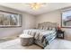 Bright bedroom with large windows, plush carpeting and a comfortable upholstered bed at 3312 S Ouray Way, Aurora, CO 80013