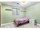Cozy bedroom with green walls, large window, and single bed at 3312 S Ouray Way, Aurora, CO 80013