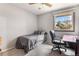 Neutral bedroom includes a single bed, desk and chair with a bright window at 3312 S Ouray Way, Aurora, CO 80013