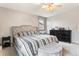 Comfortable bedroom with neutral decor, a ceiling fan and an upholstered headboard at 3312 S Ouray Way, Aurora, CO 80013
