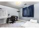 Small bedroom with a whiteboard, desk and single bed next to a window at 3312 S Ouray Way, Aurora, CO 80013