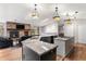 Bright, open-concept kitchen/living room area with hardwood floors and center island at 3312 S Ouray Way, Aurora, CO 80013