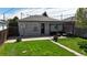 Back exterior featuring well-maintained lawn, patio area, and privacy fence at 3155 N Steele St, Denver, CO 80205
