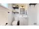 Well-lit bathroom featuring a modern vanity and decorative floating shelves at 3155 N Steele St, Denver, CO 80205