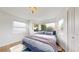 Bright bedroom featuring beautiful windows, hardwood floors, and a comfortable blue bed frame at 3155 N Steele St, Denver, CO 80205