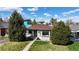 Charming home featuring new roof, brick accents, mature trees and a well-manicured lawn at 3155 N Steele St, Denver, CO 80205