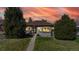 Charming home featuring a well-manicured lawn and beautiful sunset at 3155 N Steele St, Denver, CO 80205