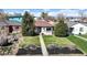 Well-maintained home with a lush front lawn and mature trees at 3155 N Steele St, Denver, CO 80205