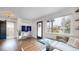 Bright living space featuring hardwood floors, a cozy seating area, and easy access to the bathroom at 3155 N Steele St, Denver, CO 80205