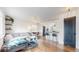 Open-concept living area with hardwood floors, modern lighting, and seamless kitchen access at 3155 N Steele St, Denver, CO 80205