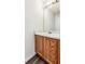 Small bathroom with wood vanity and a mirror at 20493 E Hampden Pl, Aurora, CO 80013