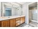 Double sink bathroom with wood cabinets at 20493 E Hampden Pl, Aurora, CO 80013