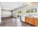 Kitchen with wood cabinets, white appliances, and access to backyard at 20493 E Hampden Pl, Aurora, CO 80013