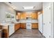 Eat-in kitchen with wood cabinets and white appliances at 20493 E Hampden Pl, Aurora, CO 80013