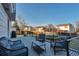 Backyard patio with wicker seating, grill, and a view of the fenced yard and neighborhood homes at 5431 E 129Th Ave, Thornton, CO 80241