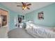 Bright bedroom with turquoise walls, ceiling fan, carpet floors, large closet and white furniture at 5431 E 129Th Ave, Thornton, CO 80241