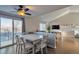 Dining area adjacent to the living room features a modern light fixture and access to an outdoor space at 5431 E 129Th Ave, Thornton, CO 80241