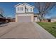 Two-story home boasts an attached garage, well-maintained lawn, and a classic suburban facade at 5431 E 129Th Ave, Thornton, CO 80241
