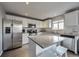 Stylish kitchen featuring stainless appliances, an island with seating, and plenty of counter space at 5431 E 129Th Ave, Thornton, CO 80241