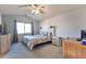 Comfortable main bedroom featuring a ceiling fan, plush carpeting, and a window with natural light at 5431 E 129Th Ave, Thornton, CO 80241