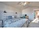 Main bedroom with vaulted ceilings, a ceiling fan, and an accent wall above the bed at 5431 E 129Th Ave, Thornton, CO 80241