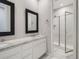 Bright bathroom featuring double sinks, granite countertops, and a glass enclosed shower at 10371 Harrisburg St, Parker, CO 80134