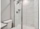 Modern bathroom featuring a glass enclosed shower with a white tile surround, and tile flooring at 10371 Harrisburg St, Parker, CO 80134