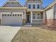 Charming two-story home with a well-kept lawn, a welcoming front porch, and a convenient two-car garage at 10371 Harrisburg St, Parker, CO 80134