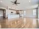 Open-concept kitchen with white cabinetry, modern stainless-steel appliances, and hardwood floors at 10371 Harrisburg St, Parker, CO 80134